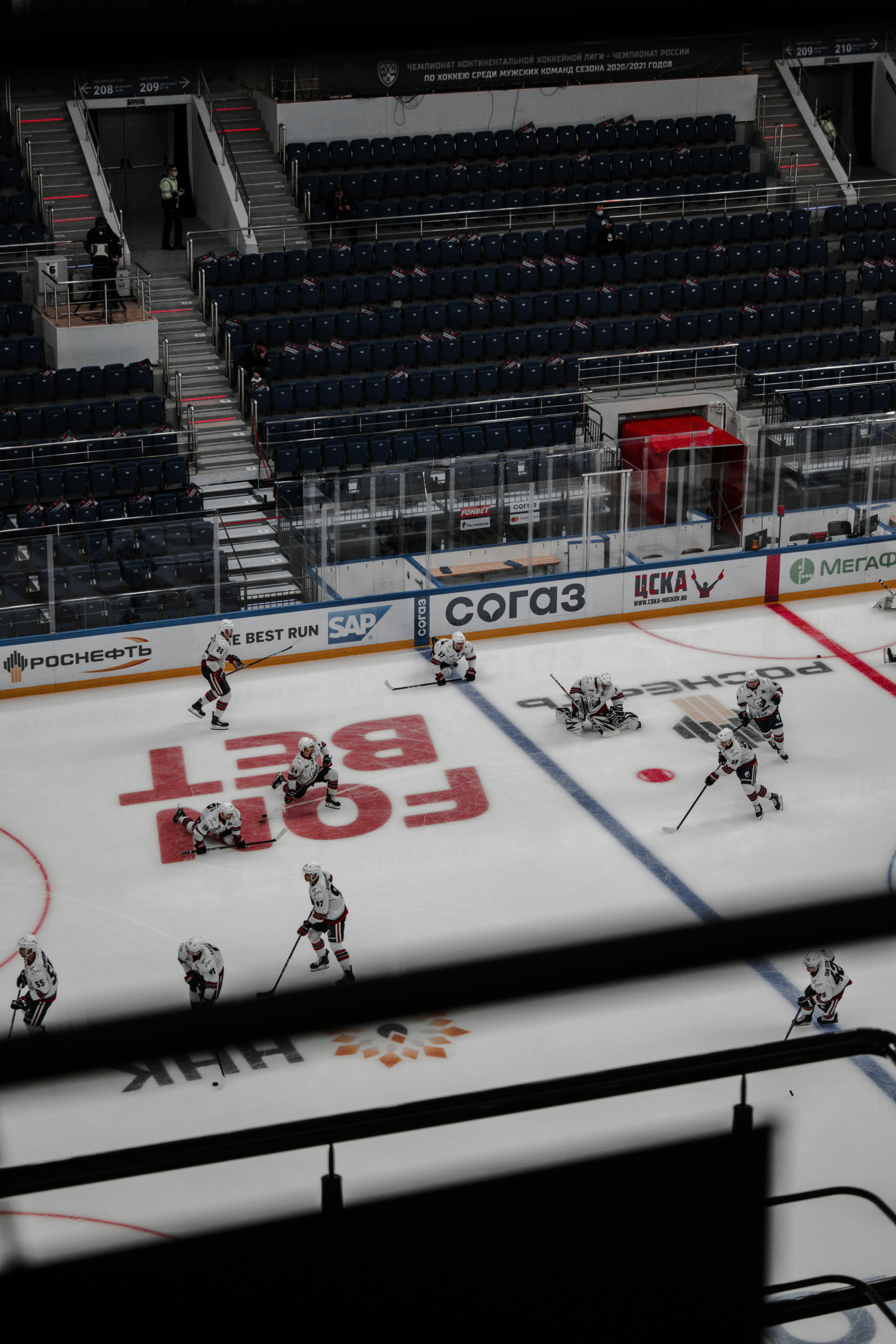 people playing ice hockey inside stadium